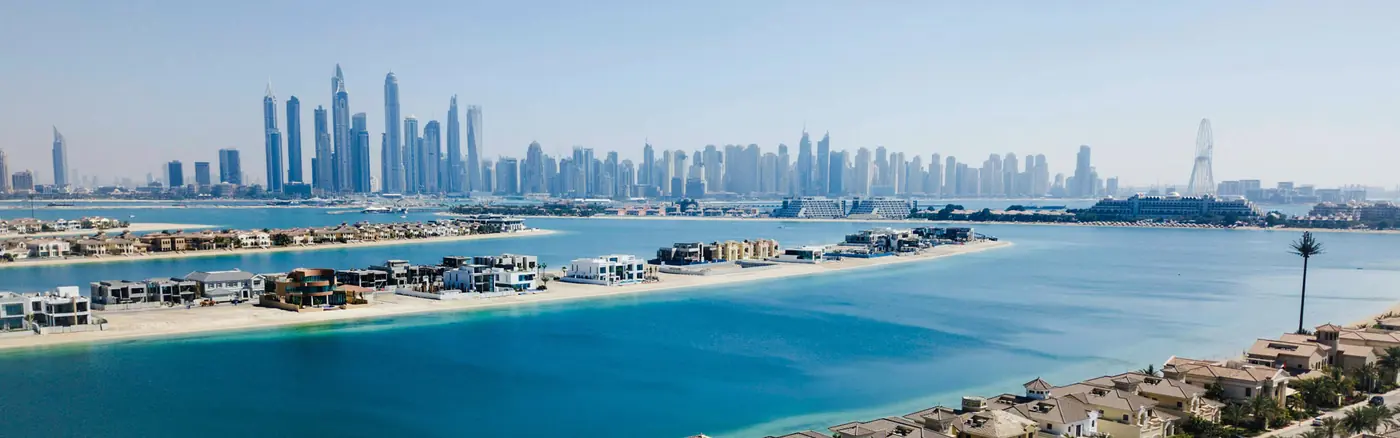 Aerial view of Dubai coastline, villas and city skyline